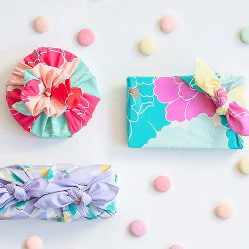 Bento box wrapped in Hime Musubi Botan Furoshiki with traditional Japanese knot, colorful floral cotton wrapping cloth
