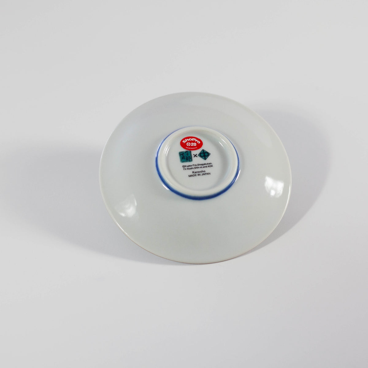 White ceramic plate with a visible brand label on a white background