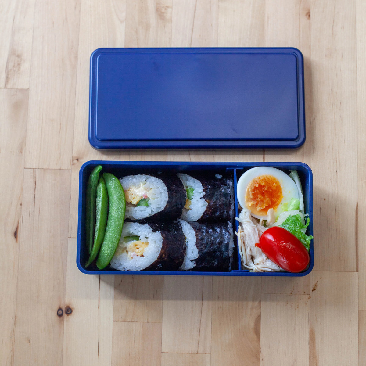 Gel-Cool Two-Tier Bento Box 1000ml in black, closed with beige elastic band, viewed straight from the front on white background