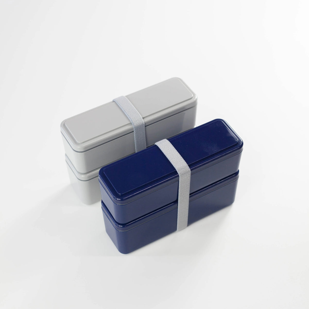 Gel-Cool Square Slim Bento Box 700ml in navy blue and grey, both two-tier with elastic band, shown side by side at an angle on white background
