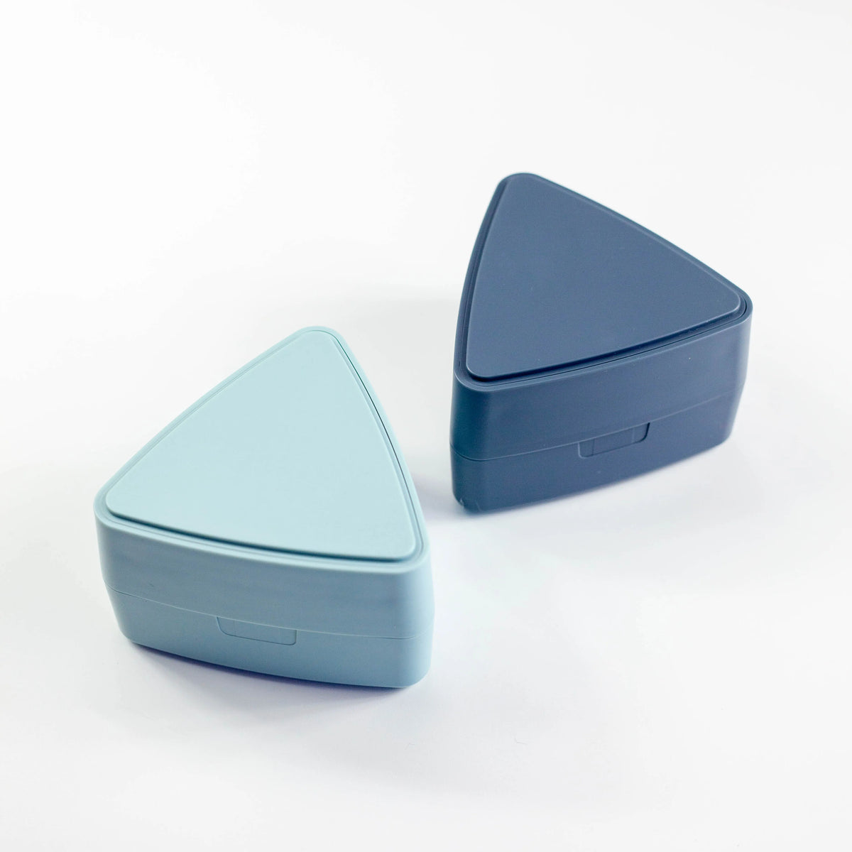 Gel-Cool Onigiri Box 180ml in light blue and navy blue, both triangle-shaped and closed, shown side by side at an angle on white background
