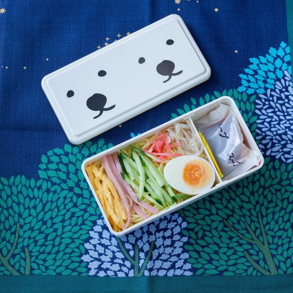 GEL-COOma Bento Box Twins open with hiyashi chuka noodle lunch on wooden table