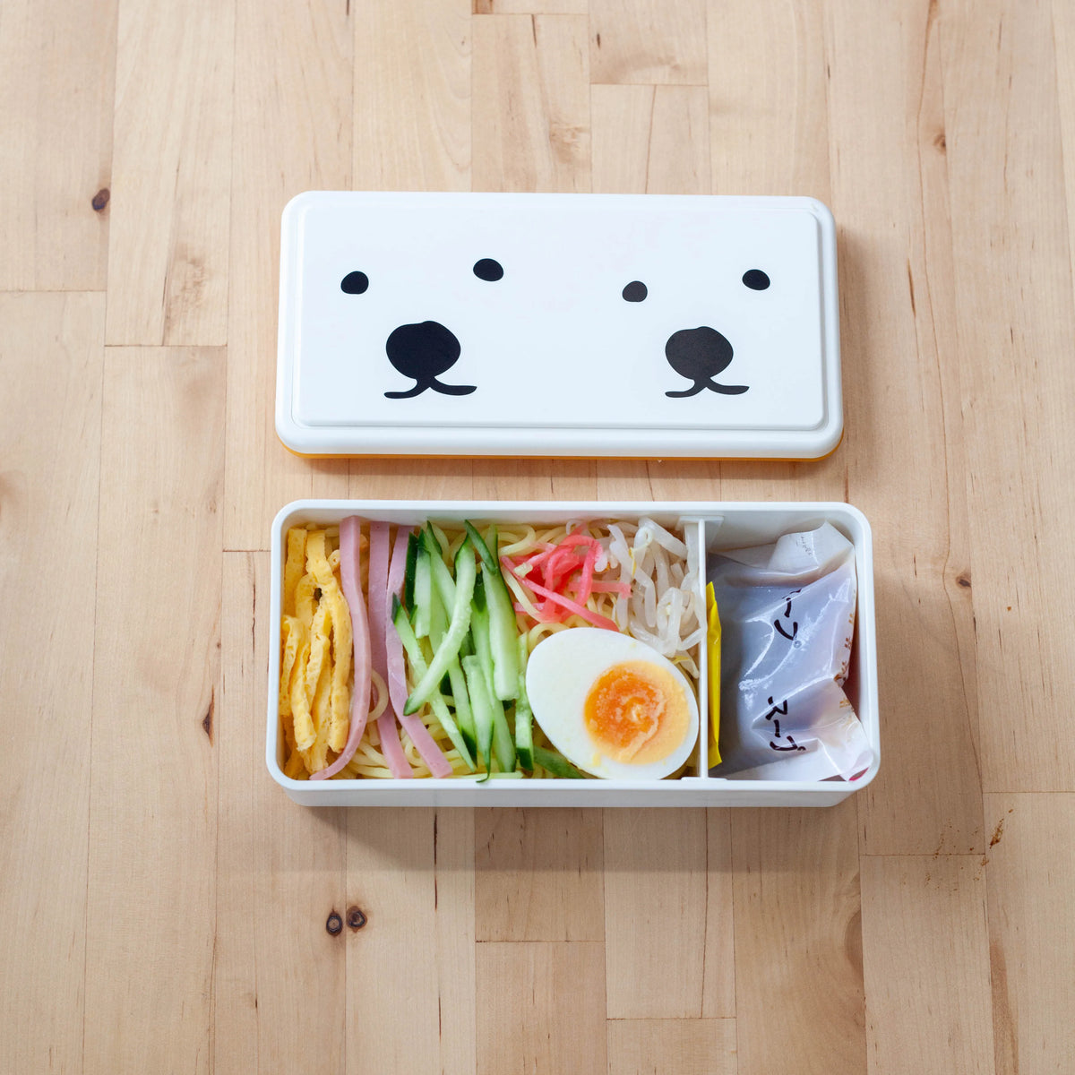 GEL-COOma Bento Box Twins open with hiyashi chuka noodle lunch on wooden tabl