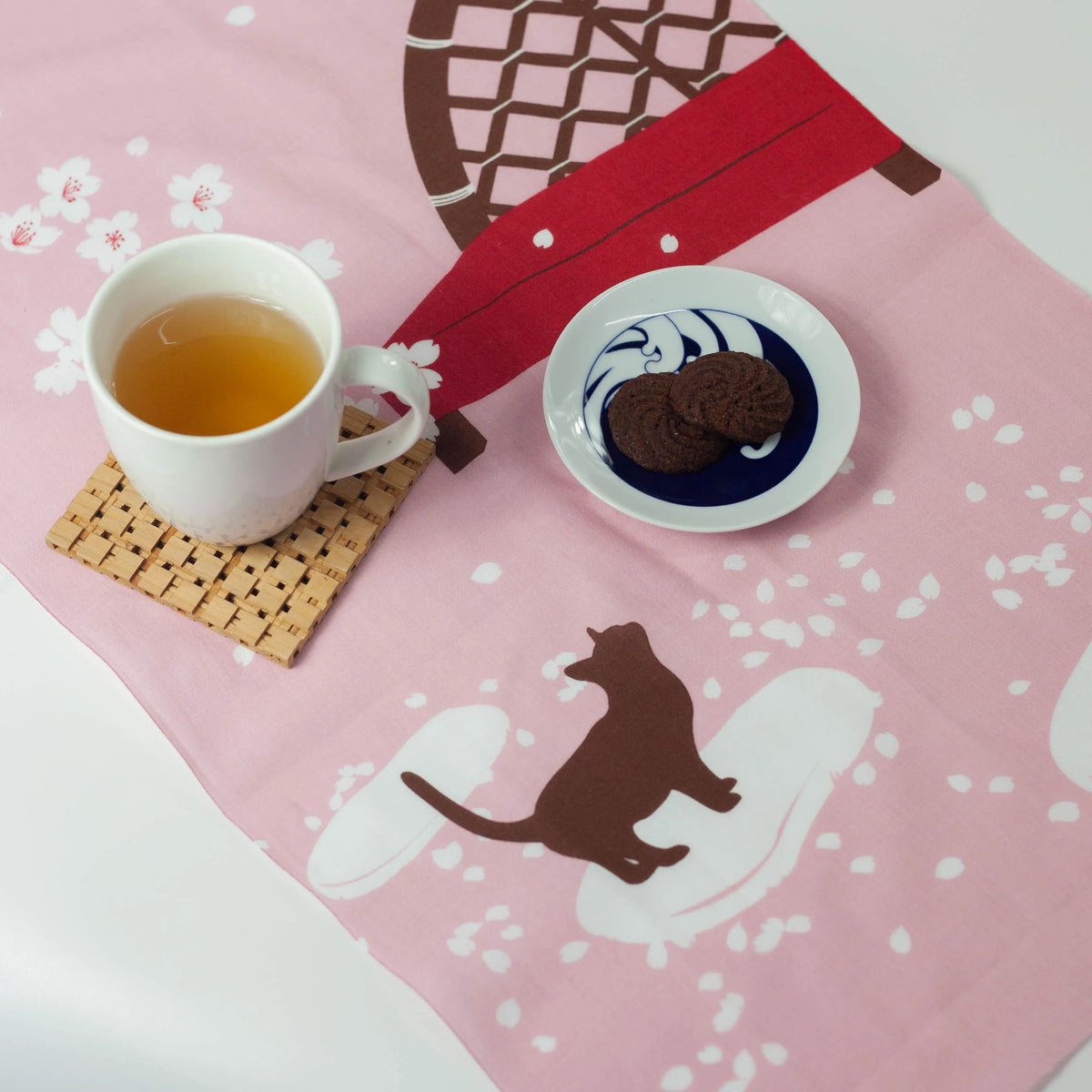 Nodate tenugui featuring a cat under a cherry tree in spring