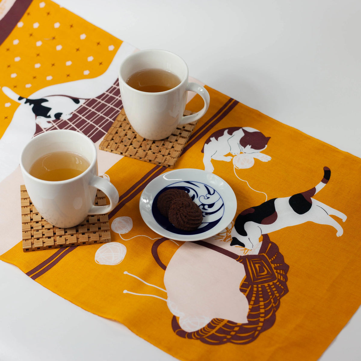 Kotatsu Neko tenugui cloth featuring cats relaxing in a Japanese living room