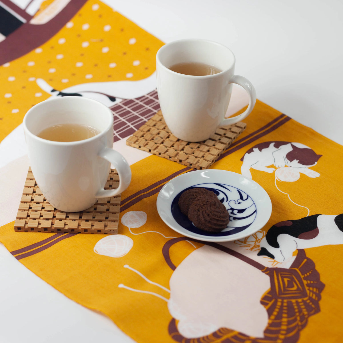 Kotatsu Neko tenugui cloth featuring cats relaxing in a Japanese living room