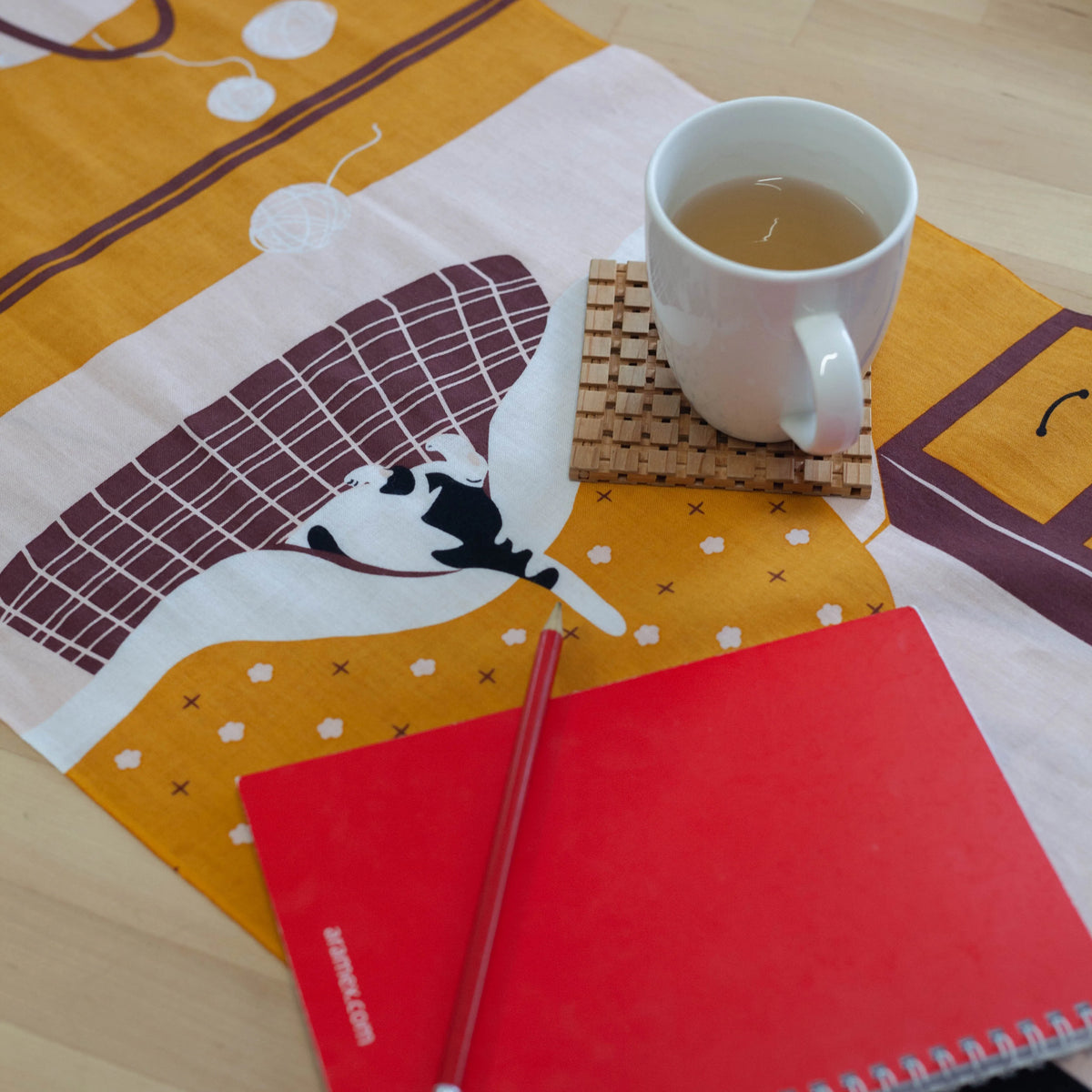 Kotatsu Neko tenugui cloth featuring cats relaxing in a Japanese living room