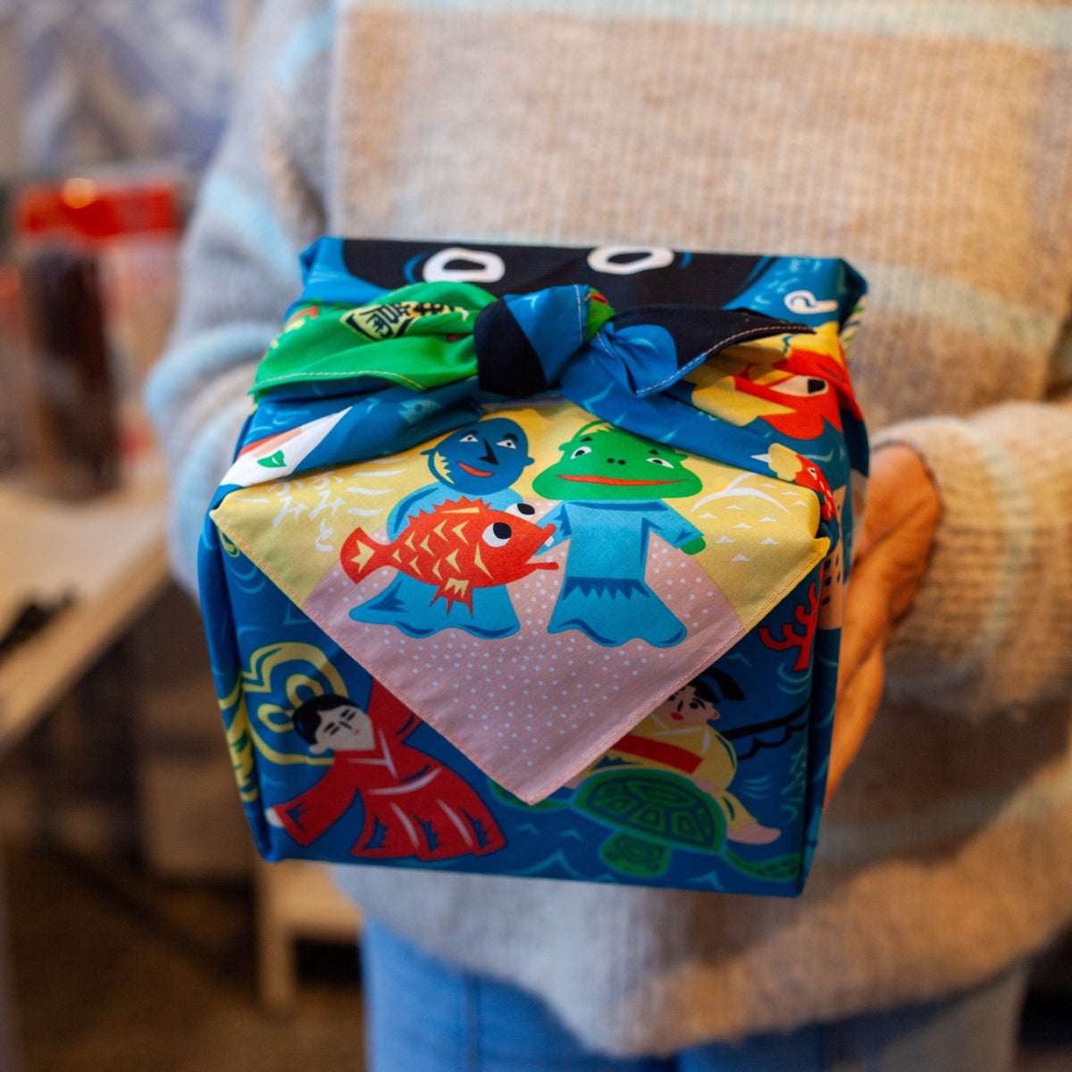 Bento box wrapped in Cochae Musubi Sea Edition Furoshiki, playful blue Japanese sea folklore organic cotton wrap