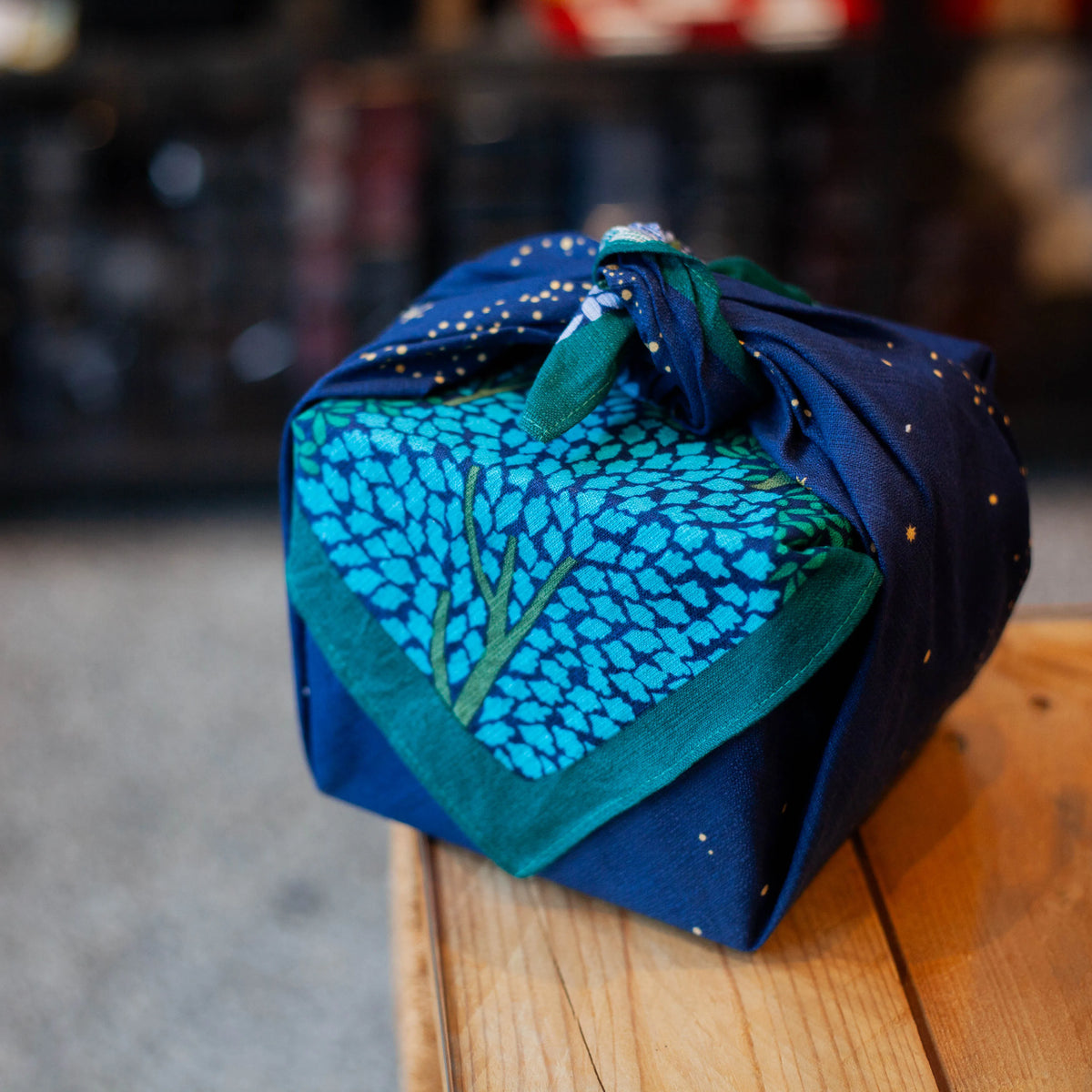 Wine bottle or gift wrapped in Hime Musubi Star Forest Furoshiki, navy starry night pattern organic cotton eco-friendly wrap