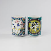 Two ceramic cups with artistic Captain Tsubasa designs on a white background