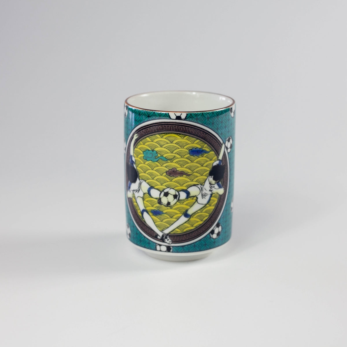 Decorative green and white mug with a soccer-themed design on a white background