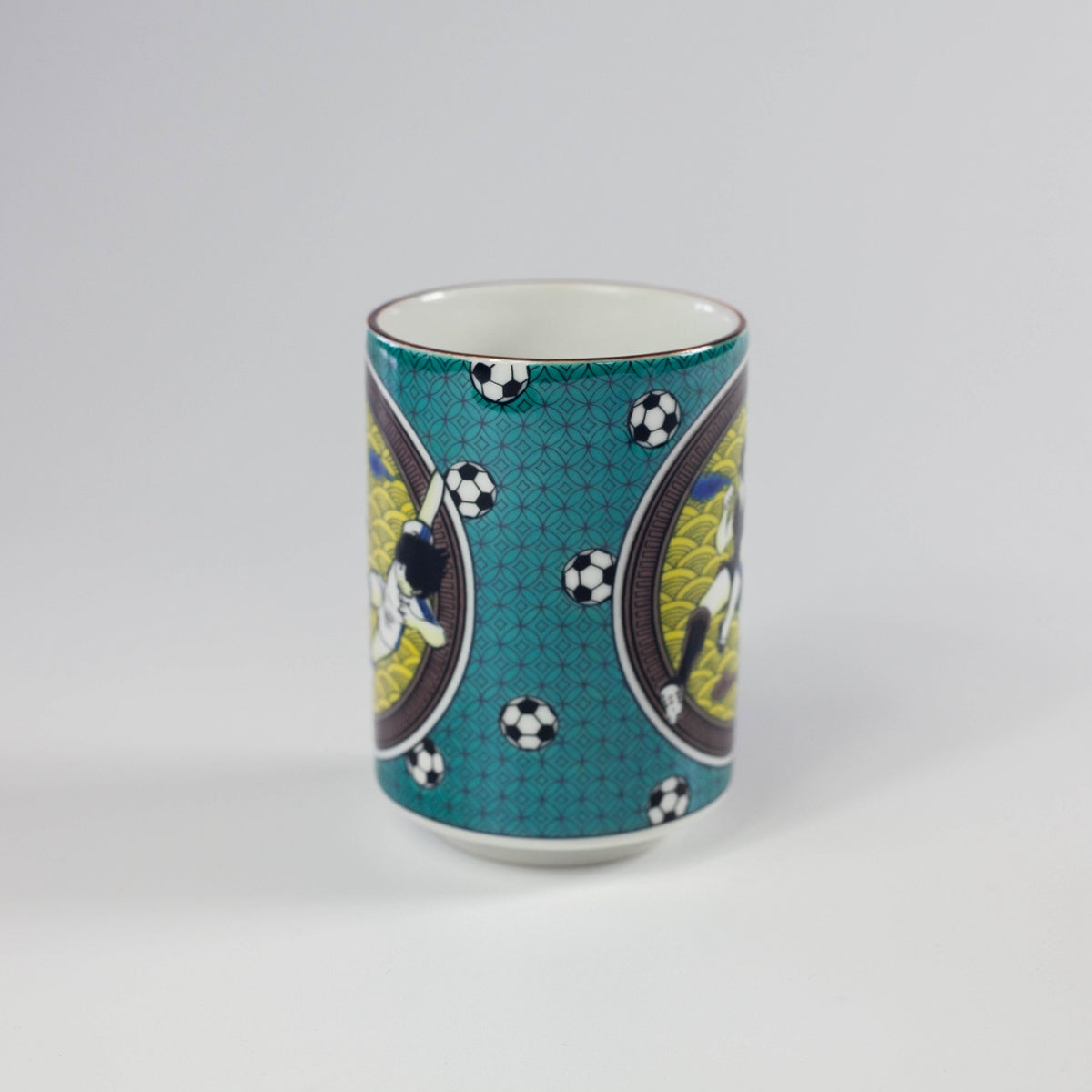 Ceramic mug with soccer-themed design on a gray background
