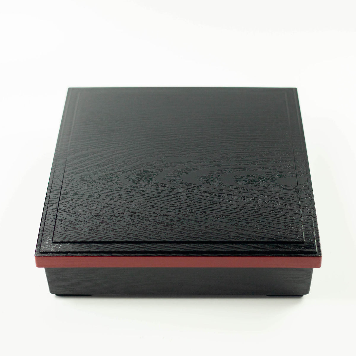 Japanese lacquerware-style bento box with black wood-grain textured lid and dark red base, elegant square lunch box, made in Japan