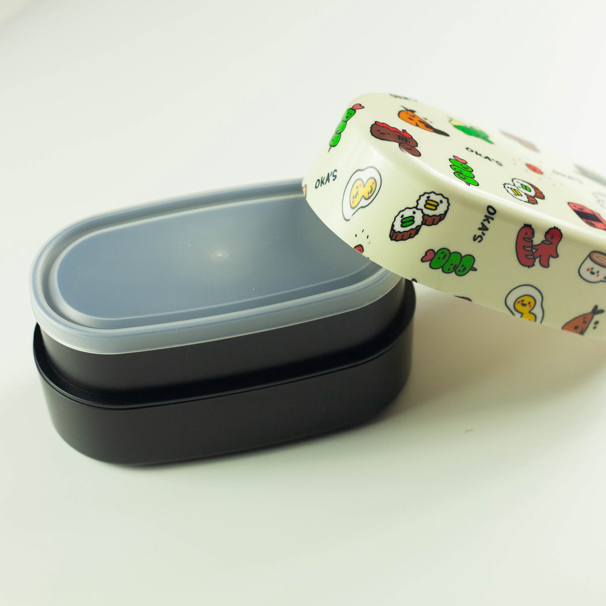 Oka's Oval Bento Box, 830ml, two-tier oval Japanese lunch box with a whimsical side-dish print