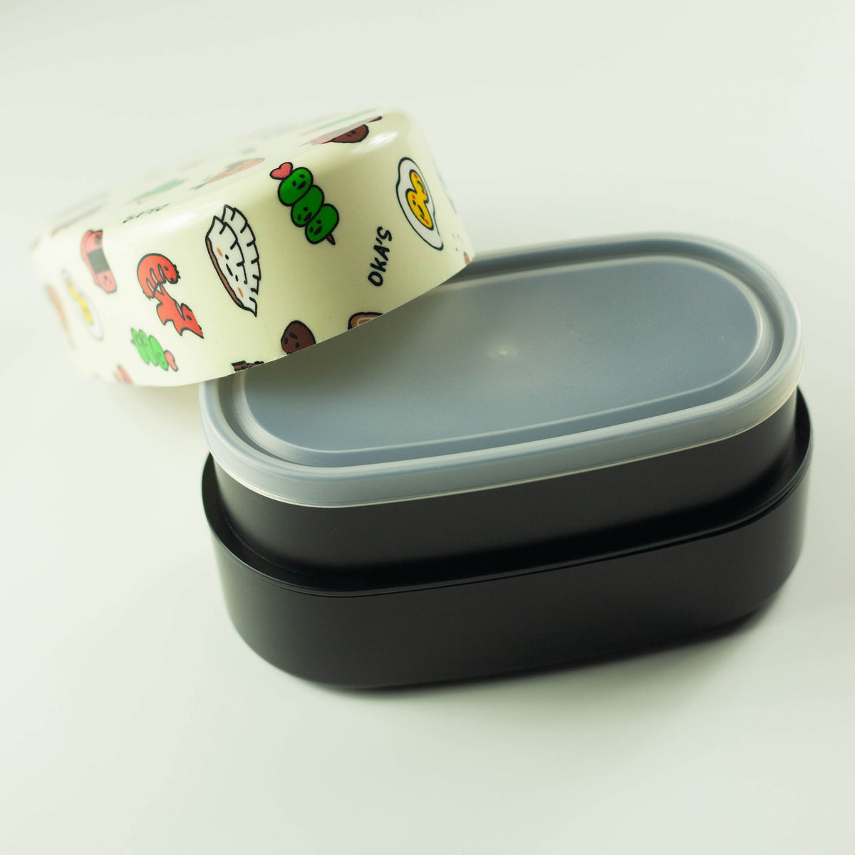Oka's Oval Bento Box, 830ml, two-tier oval Japanese lunch box with a whimsical side-dish print