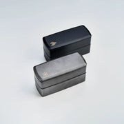 Wamon Bento Box 1000mL – bottom view of two black seigaiha and one grey maple leaf variant showing product labels