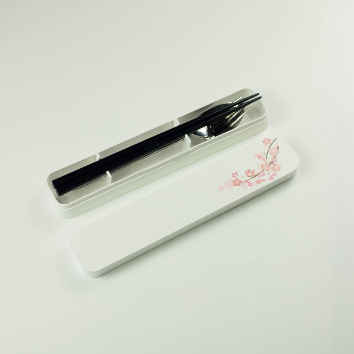 Sakura Cutlery Set white case closed, angled view showing pink cherry blossom branch design on white background
