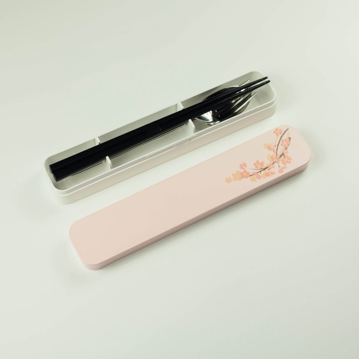 Sakura Cutlery Set pink case closed, angled view showing cherry blossom branch design on soft pink background