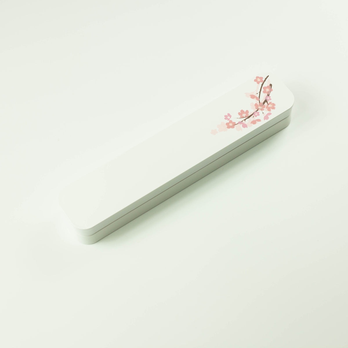 Sakura Cutlery Set white case closed, angled view showing pink cherry blossom branch design on white background