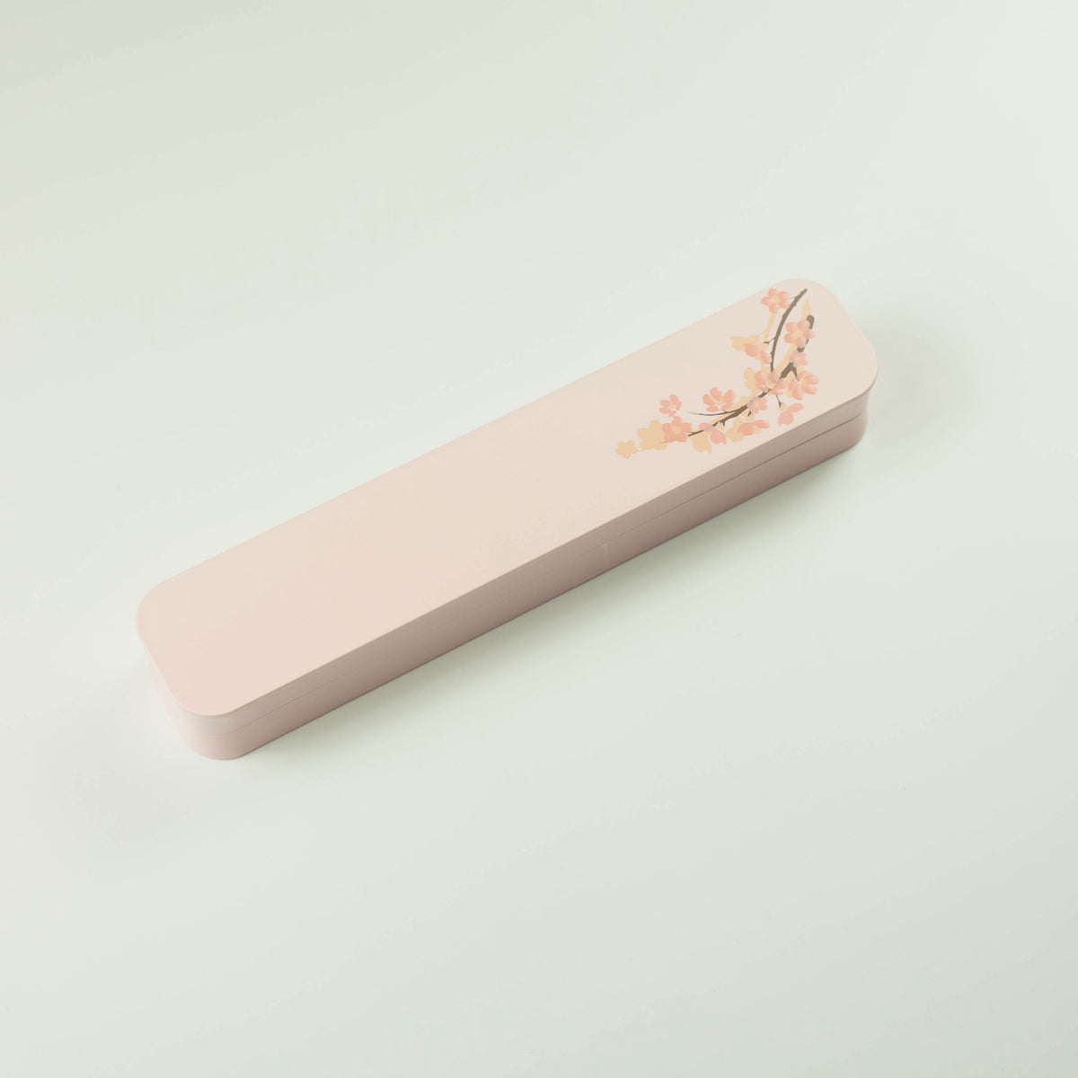Sakura Cutlery Set pink case closed, angled view showing cherry blossom branch design on soft pink background