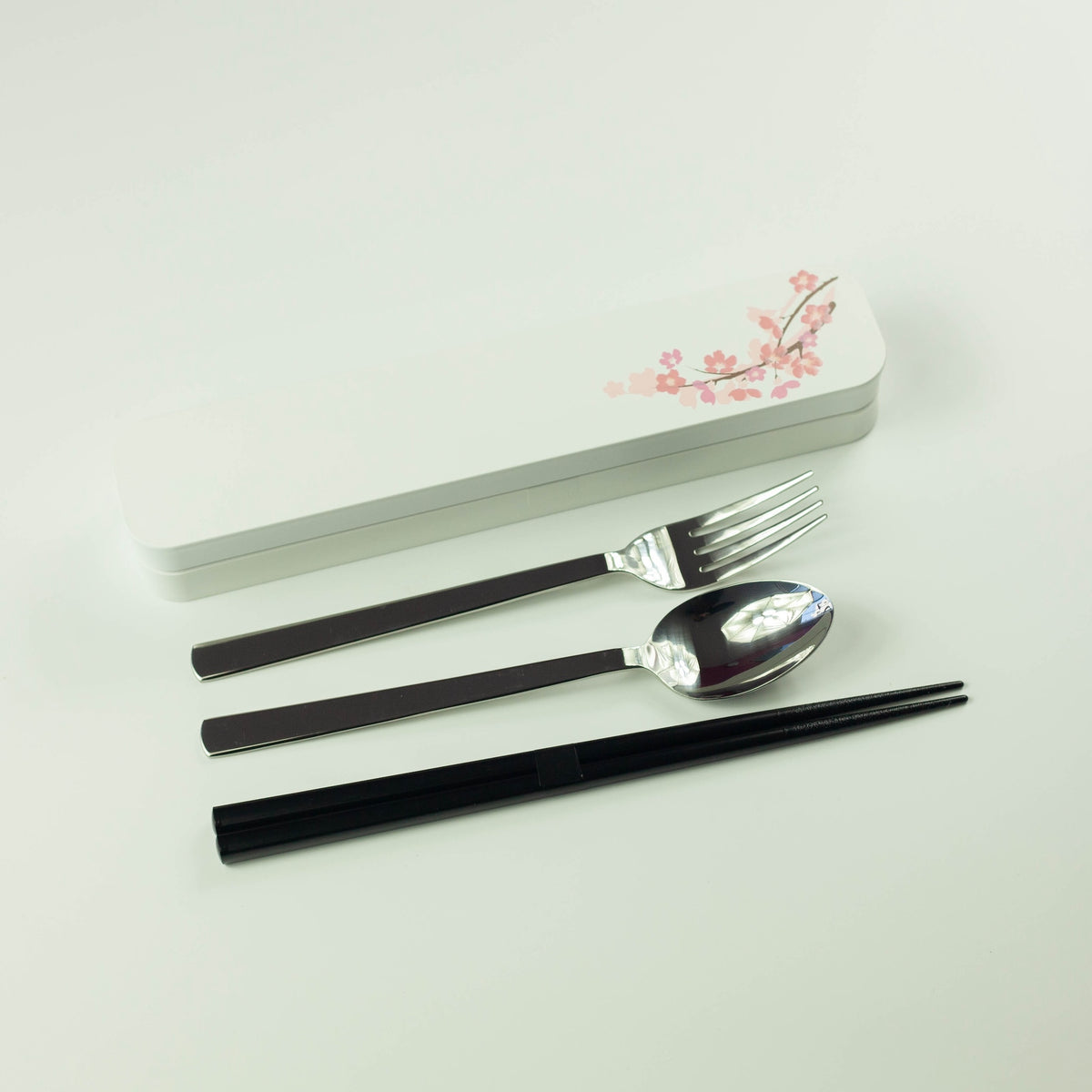 Sakura Cutlery Set white case closed, angled view showing pink cherry blossom branch design on white background