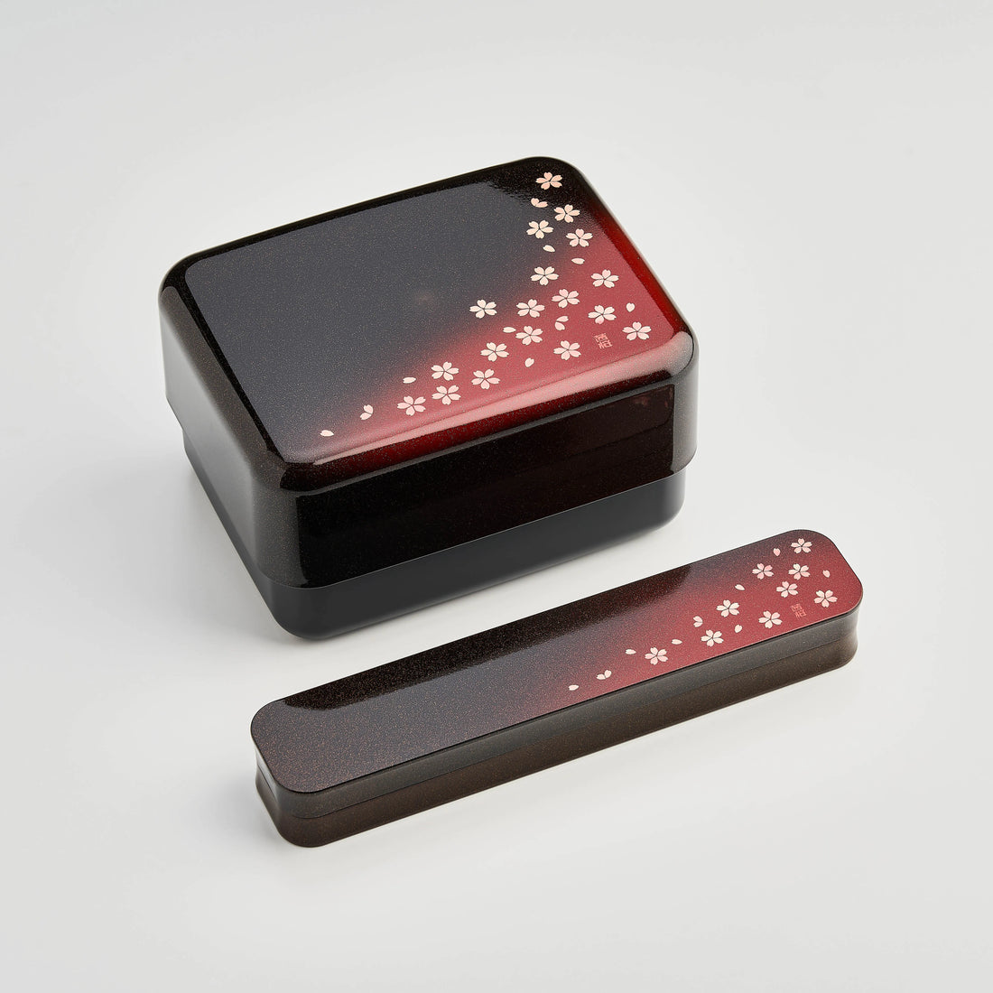 Sakura Petals Cutlery Set open case showing chopsticks, fork and spoon in black case with red cherry blossom gradient lid