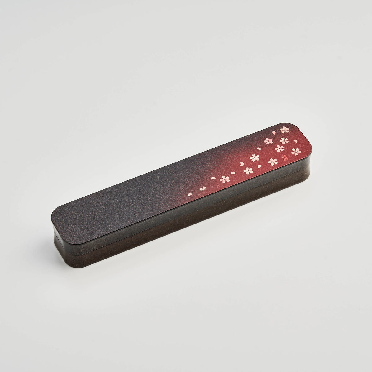 Sakura Petals Cutlery Set open case showing chopsticks, fork and spoon in black case with red cherry blossom gradient lid