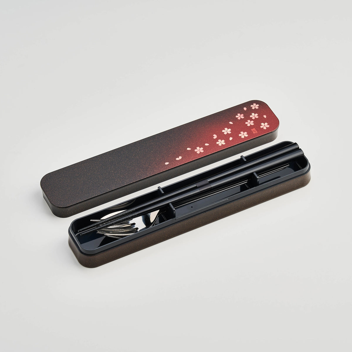 Sakura Petals Cutlery Set open case showing chopsticks, fork and spoon in black case with red cherry blossom gradient lid