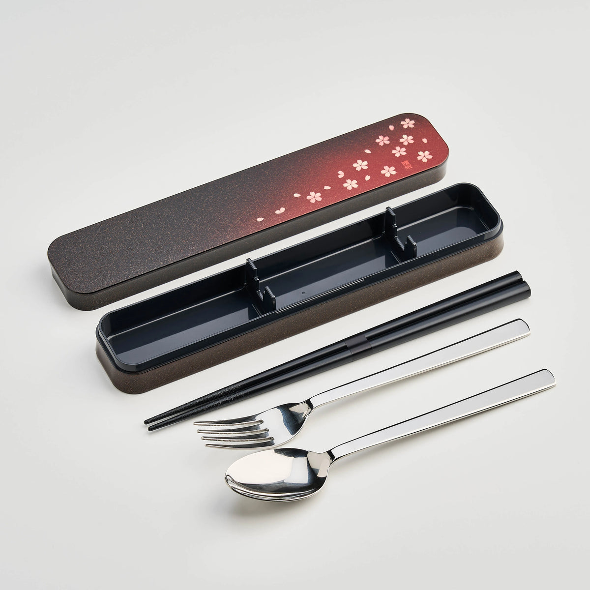 Sakura Petals Cutlery Set open case showing chopsticks, fork and spoon in black case with red cherry blossom gradient lid