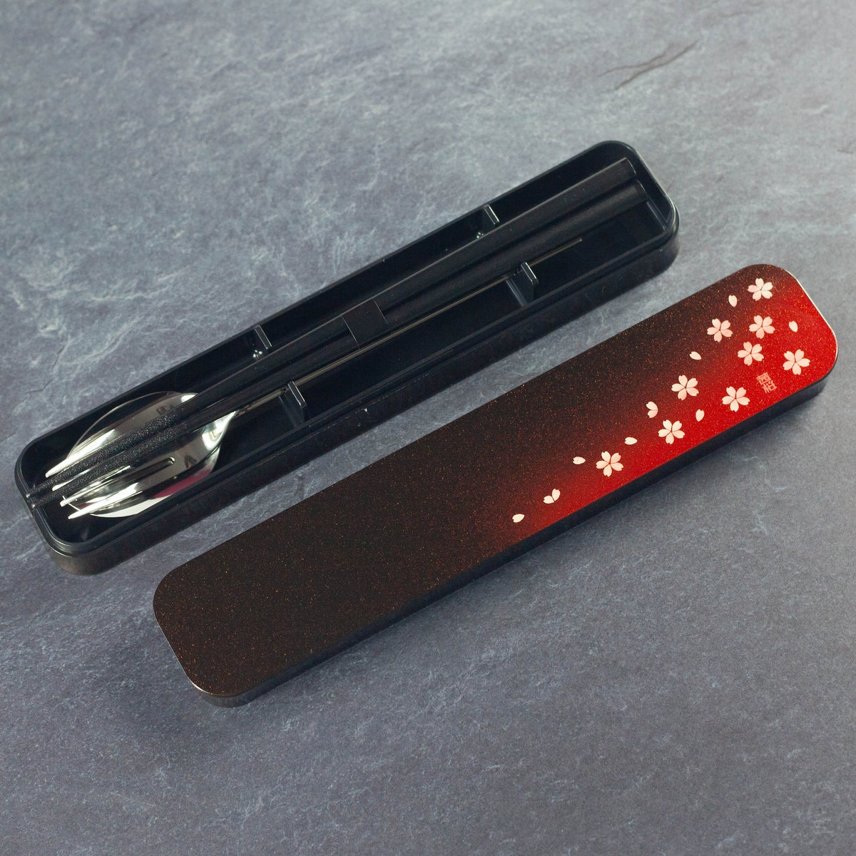 Sakura Petals Cutlery Set open case showing chopsticks, fork and spoon in black case with red cherry blossom gradient lid