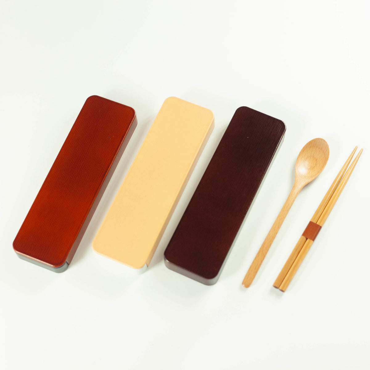 Dark brown wooden cutlery set with chopsticks, spoon and sliding case