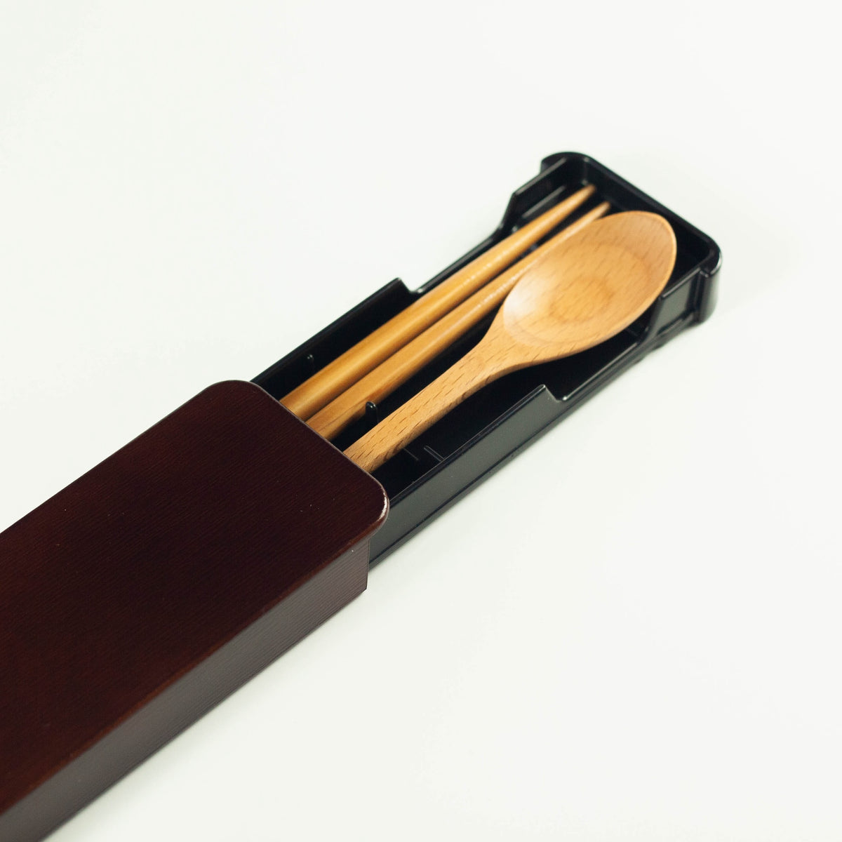 Dark brown wooden cutlery set with chopsticks, spoon and sliding case