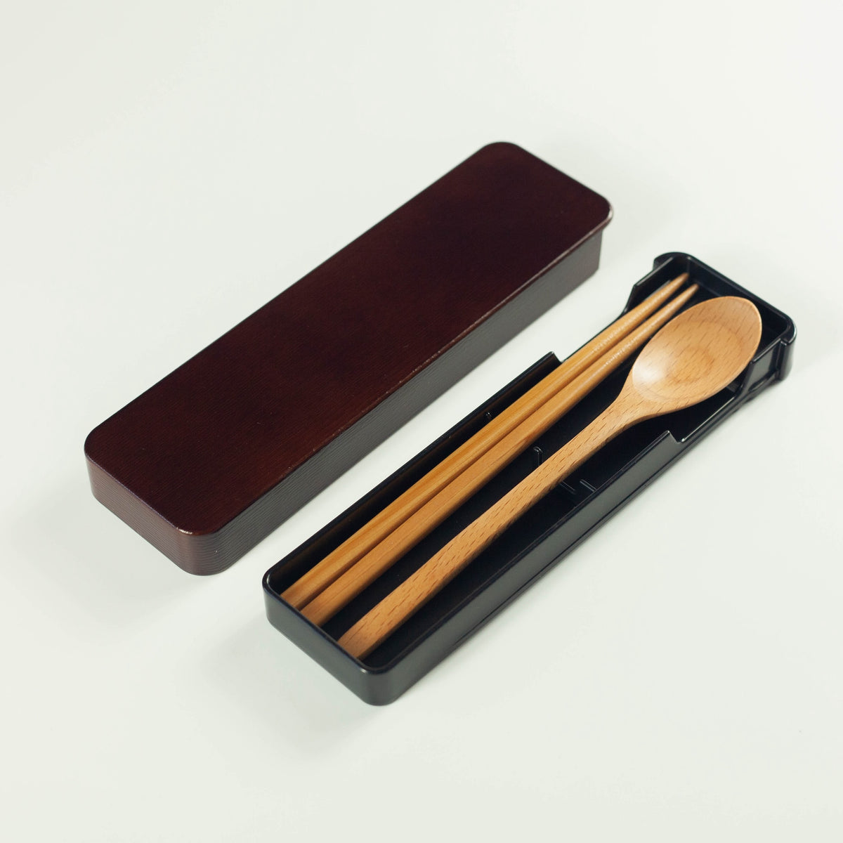 Dark brown wooden cutlery set with chopsticks, spoon and sliding case