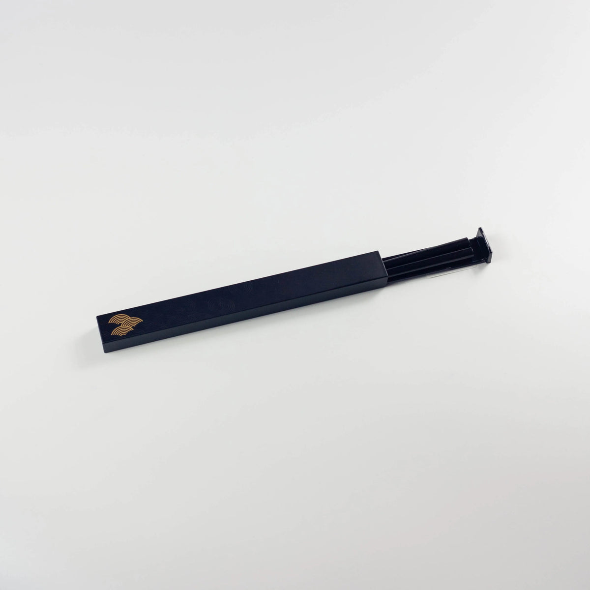 Wamon Chopsticks Set – black lacquer case with gold seigaiha wave motif, partially open showing chopsticks inside