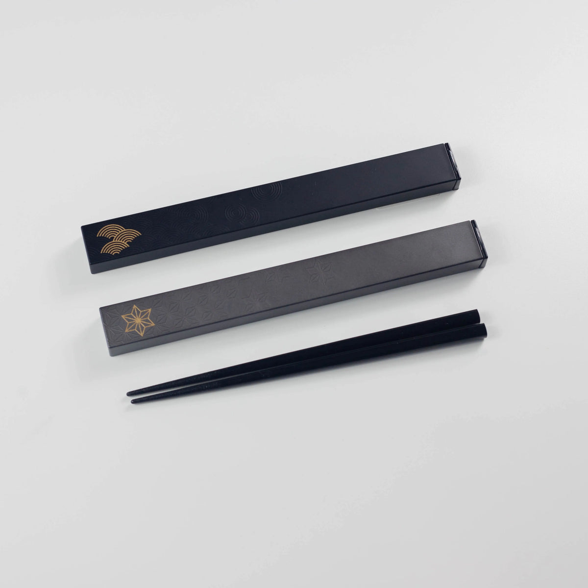 Wamon Chopsticks Set – two black lacquer cases with gold Japanese motifs (seigaiha and snowflake) and black chopsticks