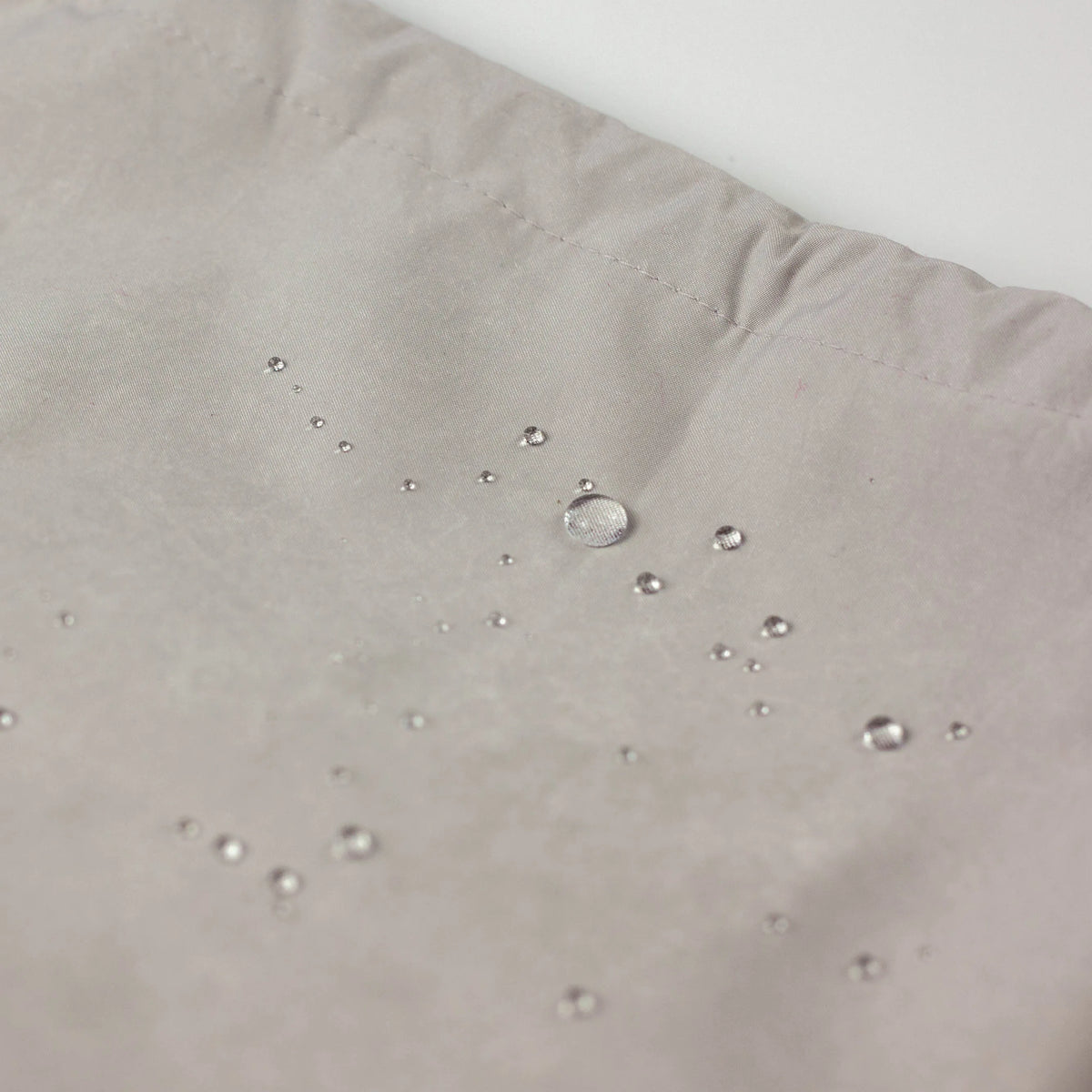 Water Repellent Drawstring Bag in  grey white with red drawstring cord, closed, front view on white background