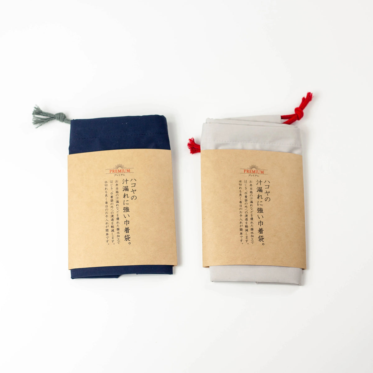 Water Repellent Drawstring Bag in light grey with red drawstring cord, closed, front view on white background