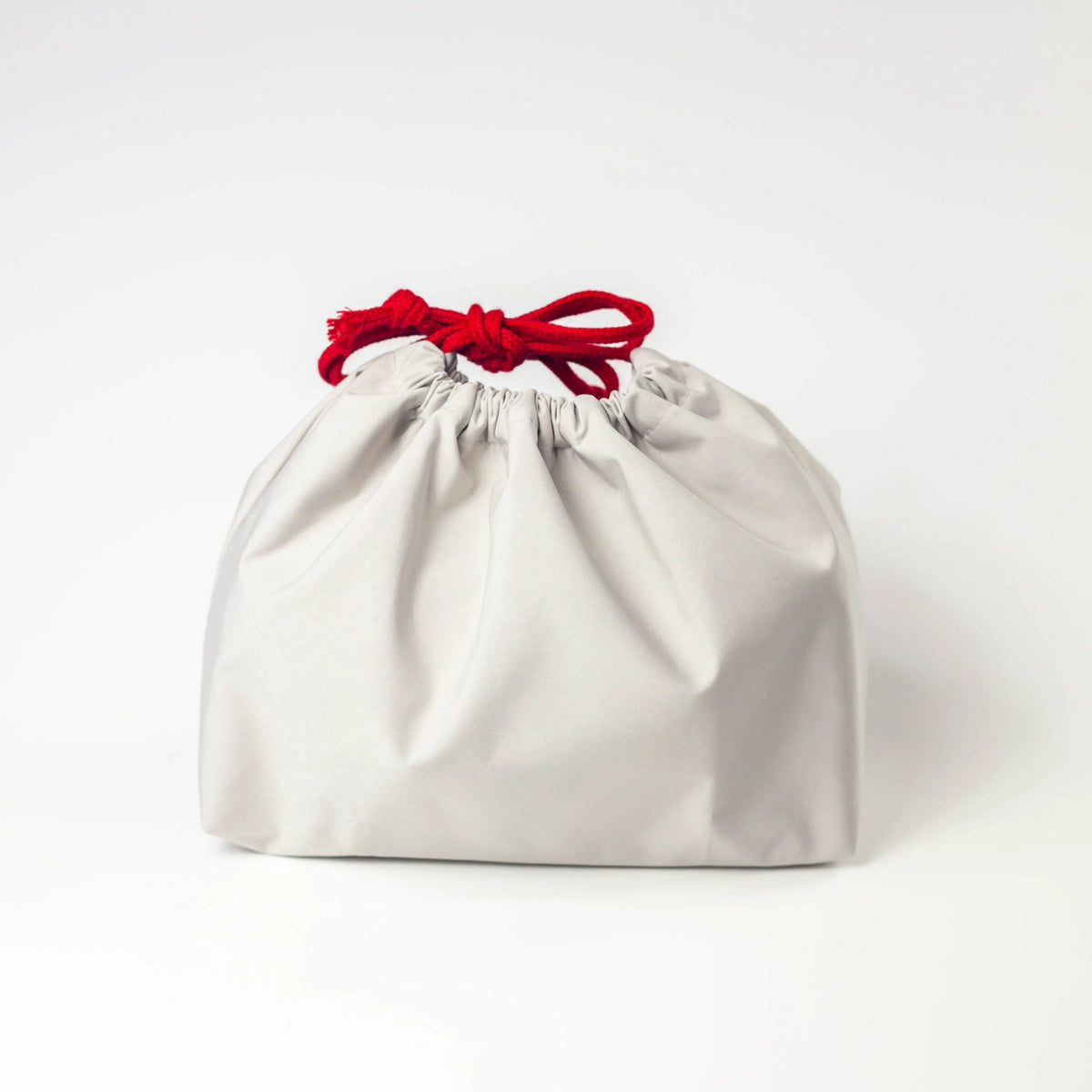 Water Repellent Drawstring Bag in  grey white with red drawstring cord, closed, front view on white background