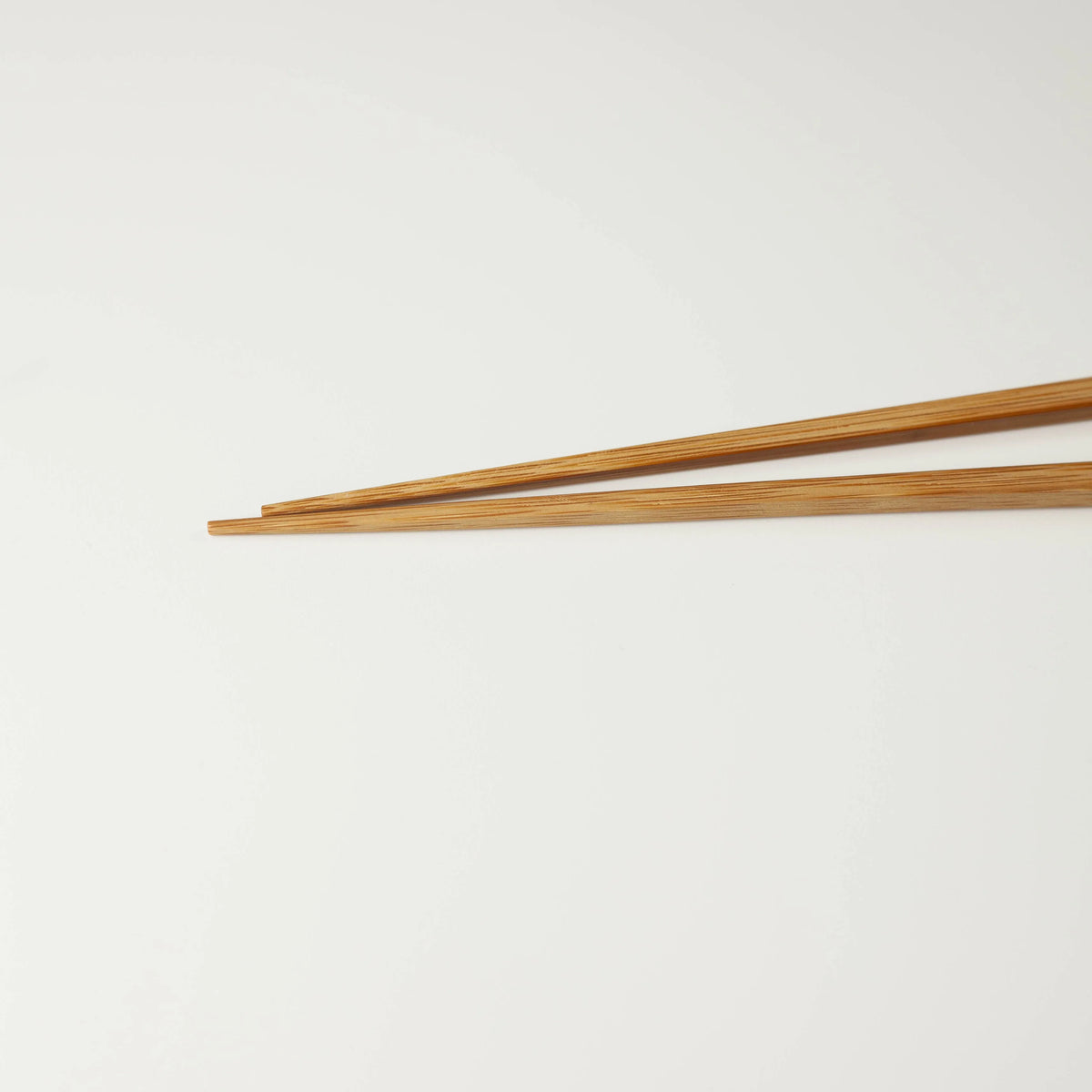 Close-up of the tapered tips and natural bamboo grain of the long bamboo chopsticks