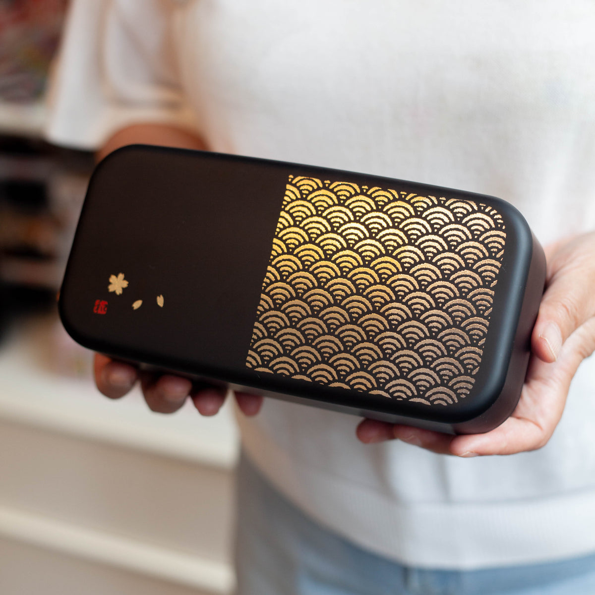 Nami Bento Box, matte-black two-tier bento box with traditional Japanese seigaiha wave pattern in muted gold, 950ml, made in Japan