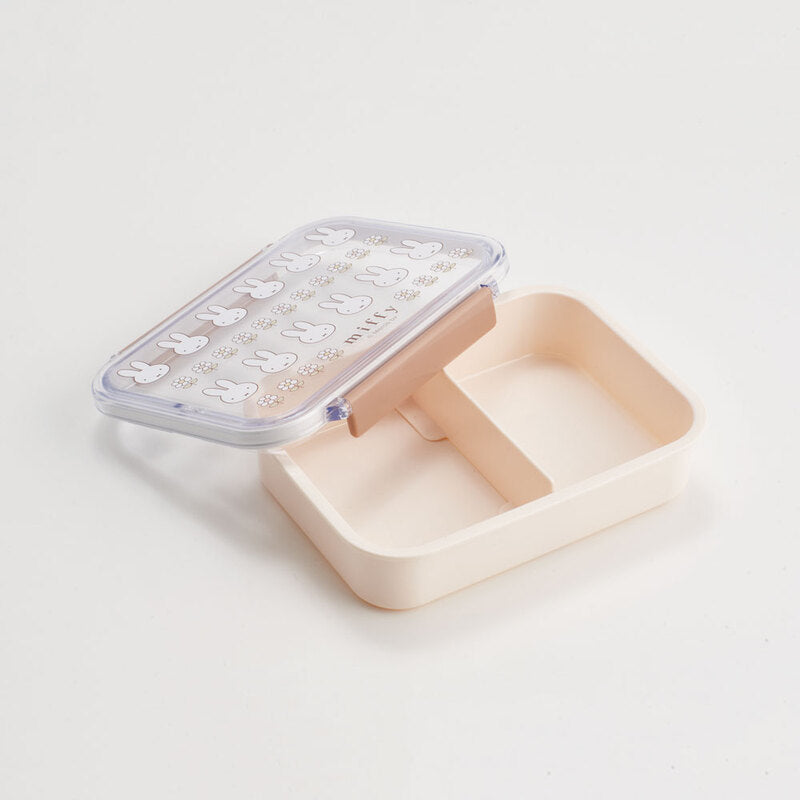 Rectangular lunch box with a bunny pattern and a beige body opened on a white background