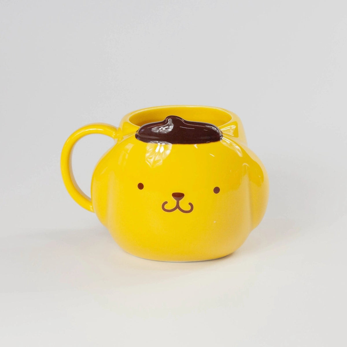 Yellow mug with a labrador face design on a white background