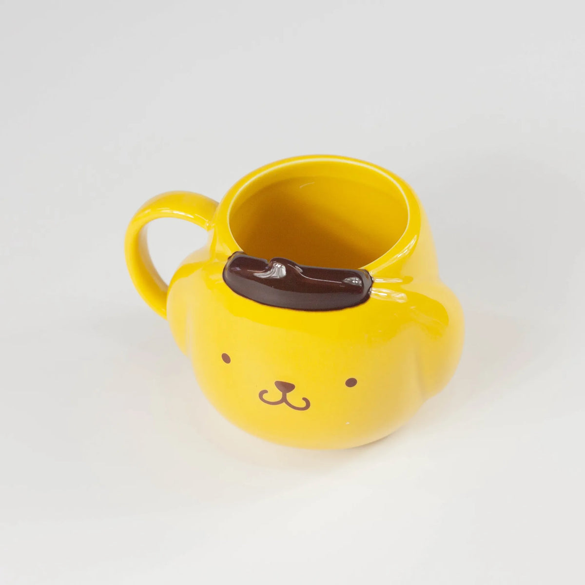 Yellow PompomPurin porcelain mug on a white background