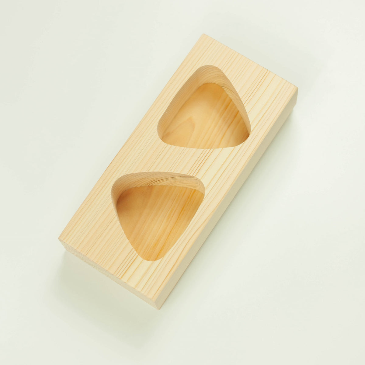 Hinoki Onigiri Mold – Japanese cypress wood rice ball mold with two triangle-shaped cavities for making perfectly shaped onigiri, shown with freshly made rice balls, made in Japan