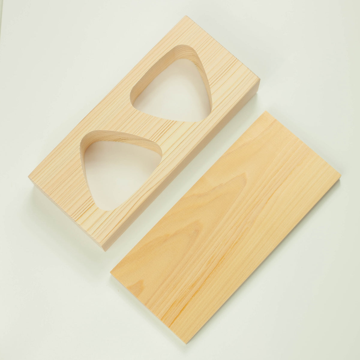 Hinoki Onigiri Mold – Japanese cypress wood rice ball mold with two triangle-shaped cavities for making perfectly shaped onigiri, shown with freshly made rice balls, made in Japan