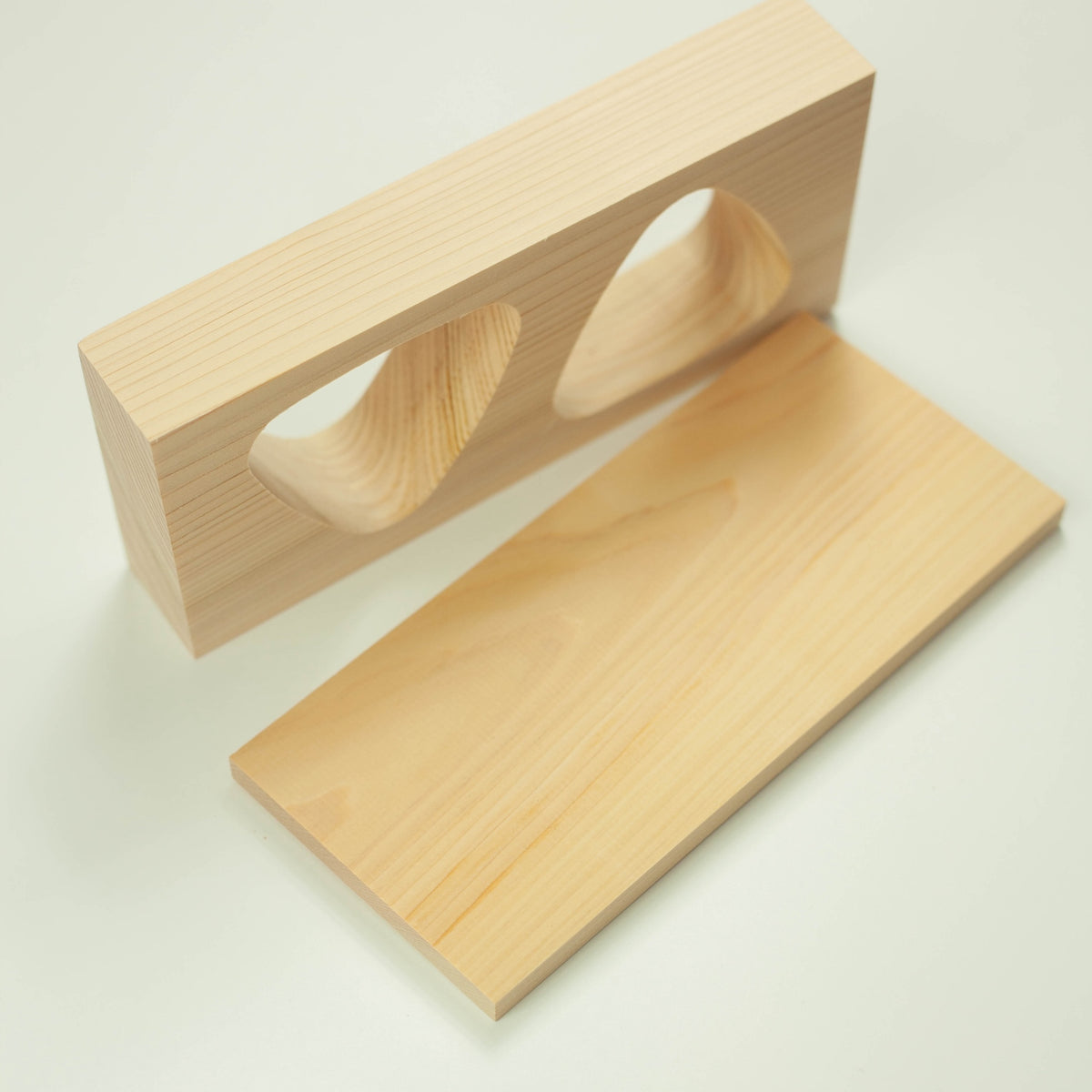 Hinoki Onigiri Mold – Japanese cypress wood rice ball mold with two triangle-shaped cavities for making perfectly shaped onigiri, shown with freshly made rice balls, made in Japan