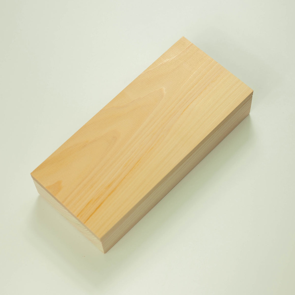 Hinoki Onigiri Mold – Japanese cypress wood rice ball mold with two triangle-shaped cavities for making perfectly shaped onigiri, shown with freshly made rice balls, made in Japan