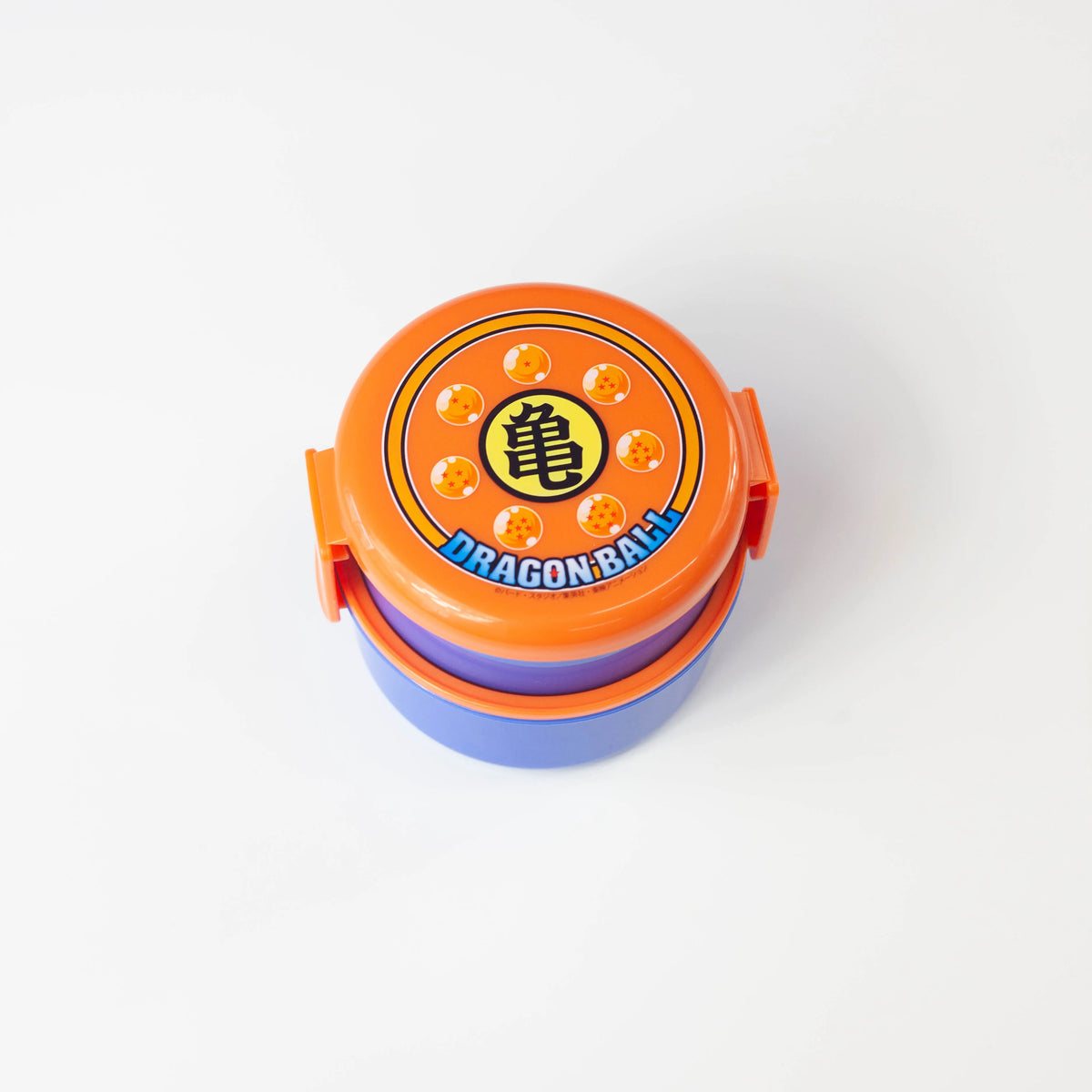 Dragon Ball round bento box in orange and blue with the Kame kanji emblem and seven Dragon Balls on the lid
