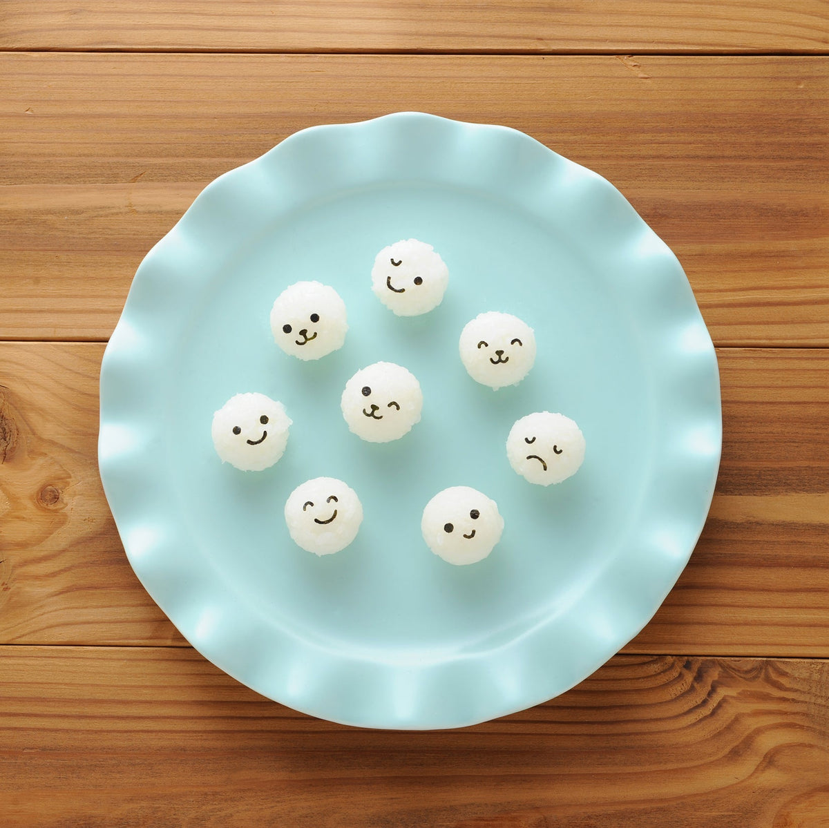 Arnest Baby Onigiri Rice Mold Set "Komusubi Ball Mini x2" retail packaging – yellow mold and two nori punches on a colorful Japanese card with product photos, on white background