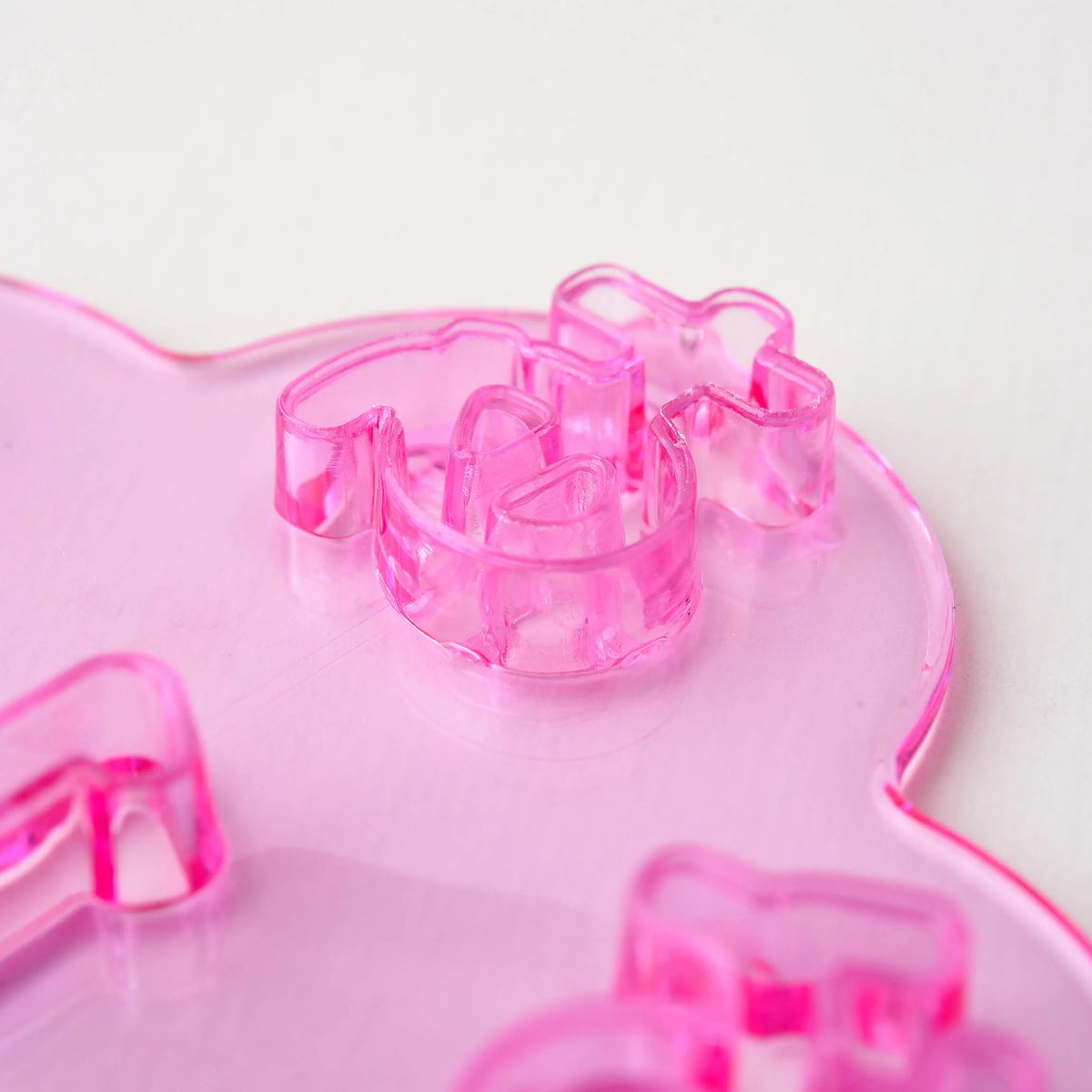 Close-up of Hiragana Cutter Set pink tray – transparent "a" (あ) character cutter showing detailed cutting edge
